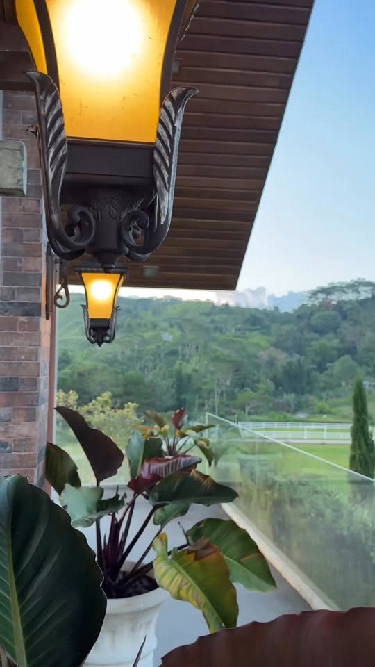 A lantern hanging over the view deck, paddocks and hills beyond