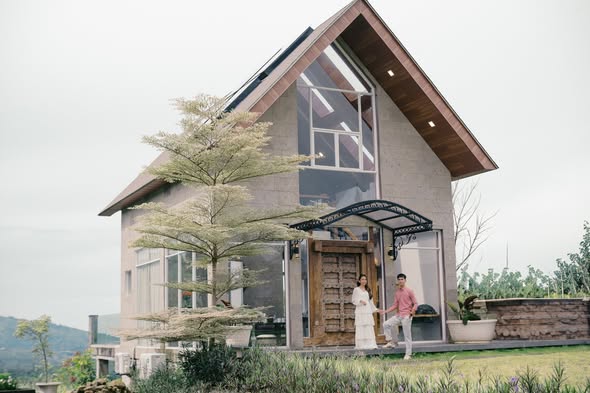 The Guest House exterior, a steep-gabled building in pale stone and glass