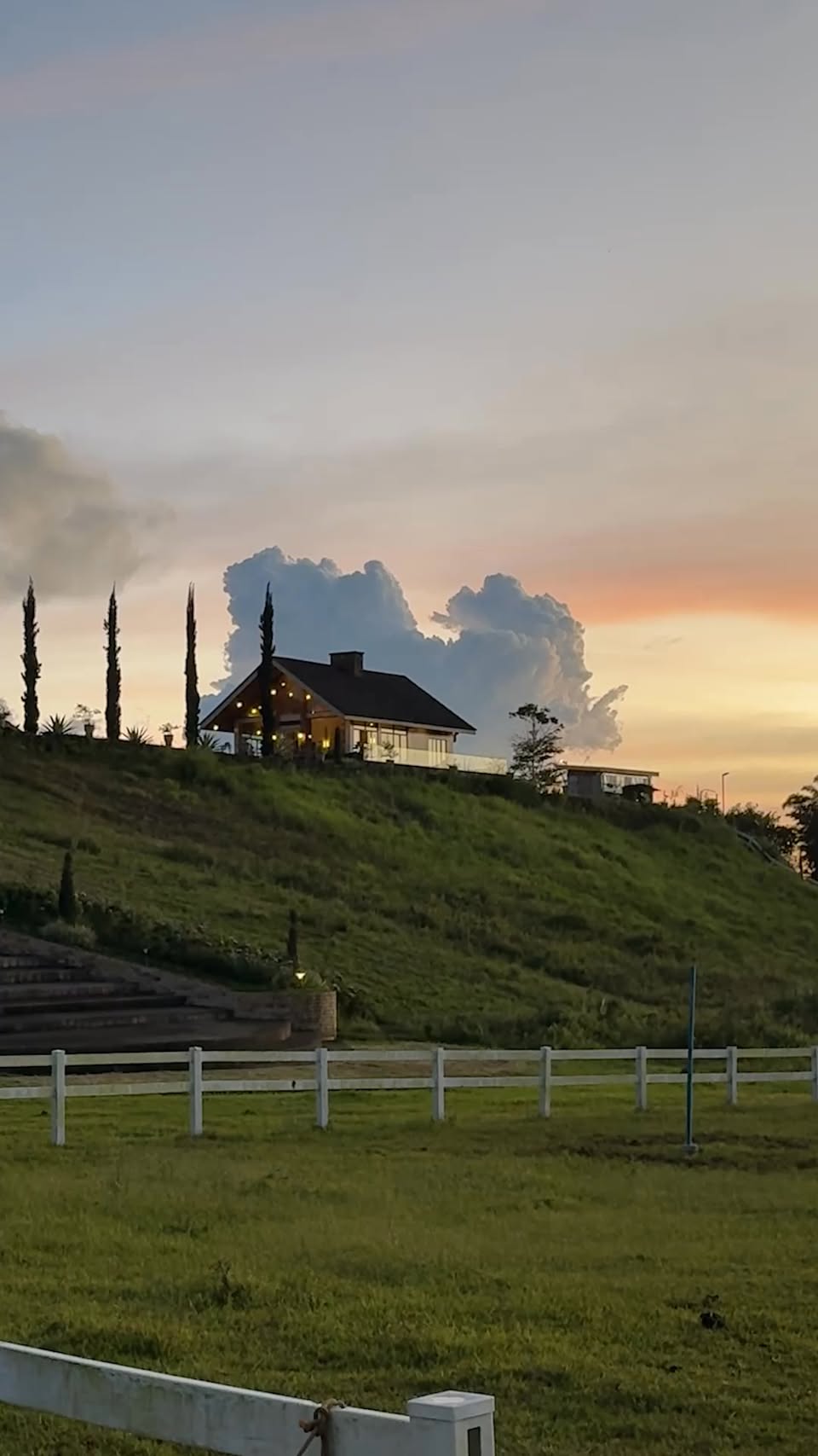 The Manor on its ridge under a burning evening sky