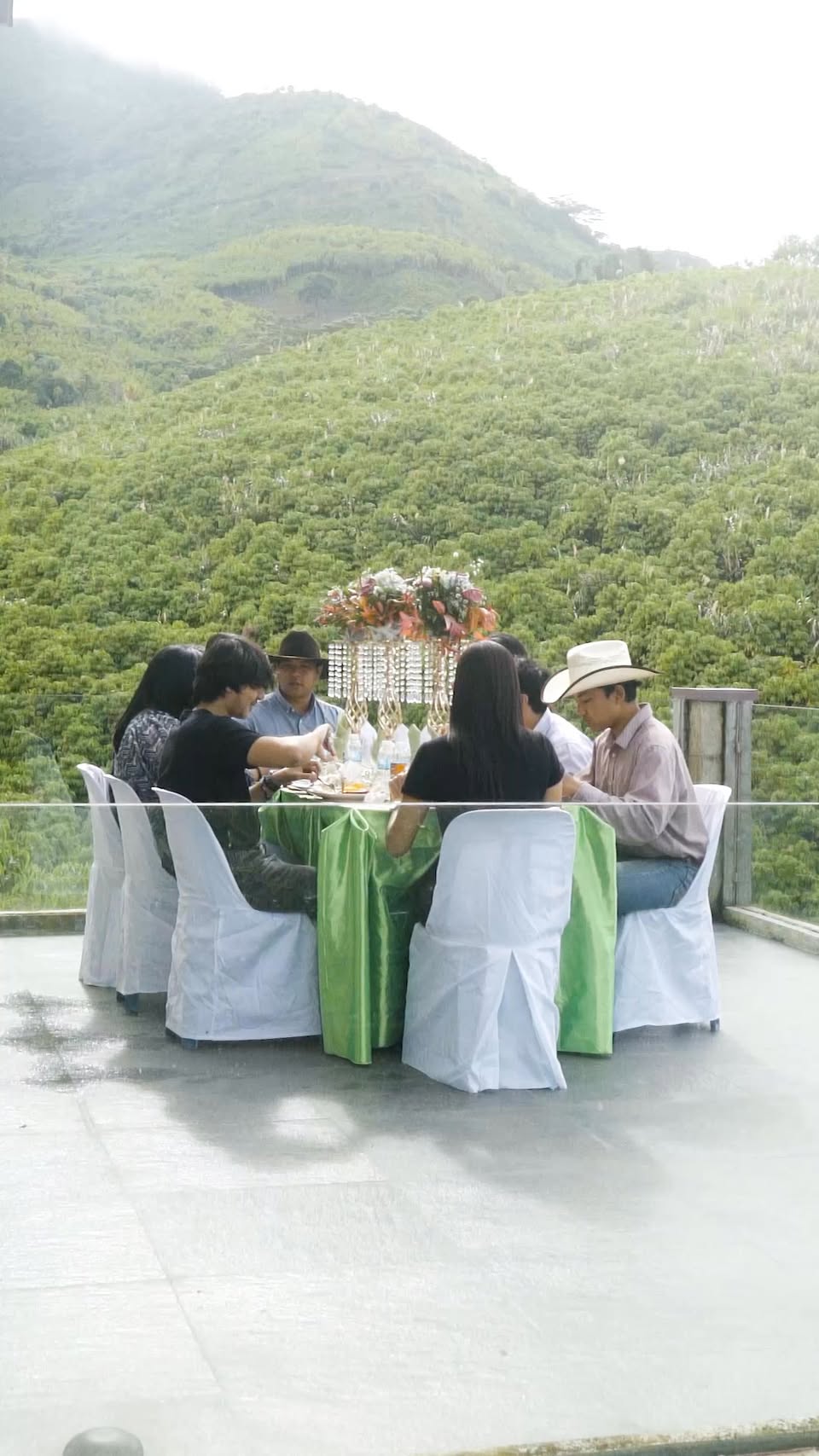 A long table laid on the terrace above the paddocks